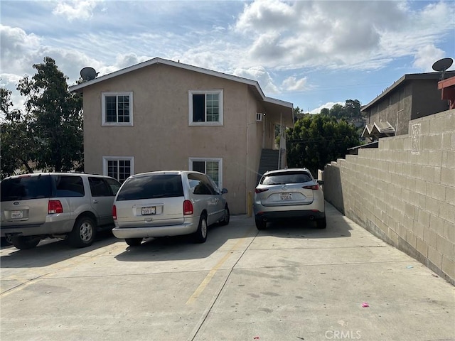 exterior space with fence and concrete driveway