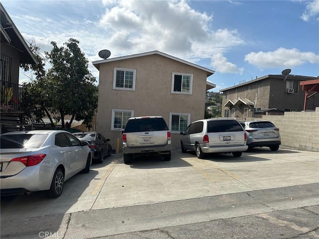 exterior space with stucco siding and fence
