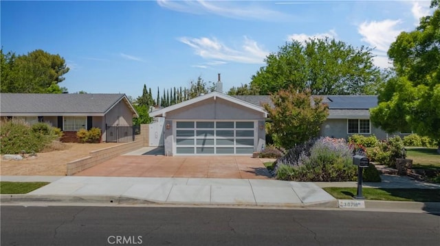 ranch-style home with a garage, a gate, and driveway