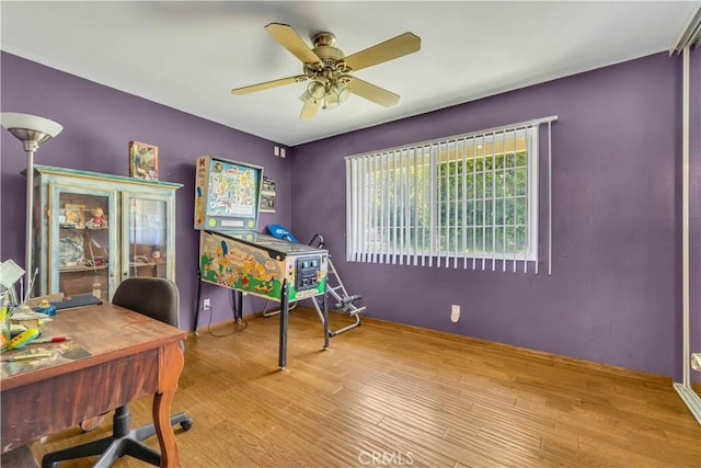 interior space with ceiling fan and wood finished floors