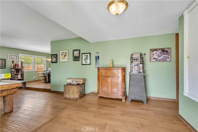 interior space with baseboards and wood finished floors