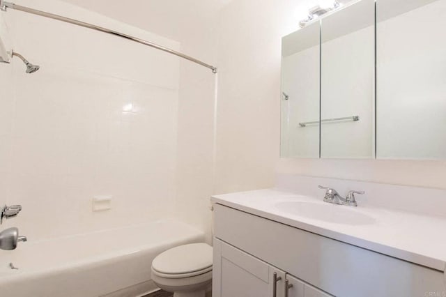 bathroom featuring vanity, washtub / shower combination, and toilet