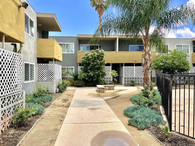 surrounding community with a patio and fence