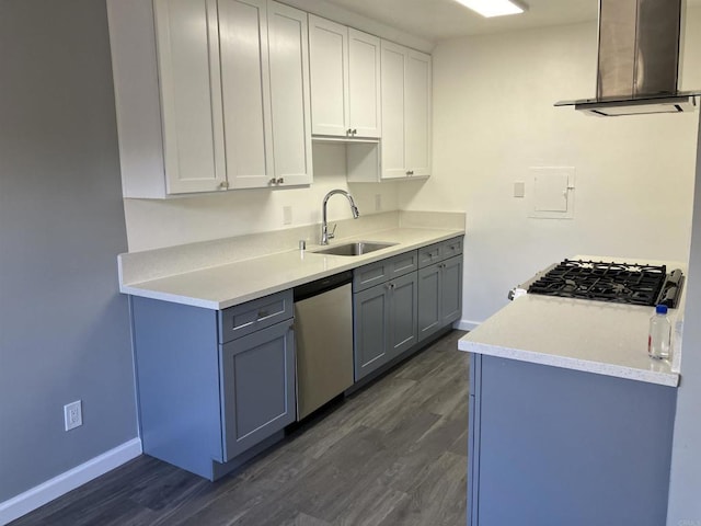 kitchen with stainless steel dishwasher, a sink, dark wood finished floors, and extractor fan
