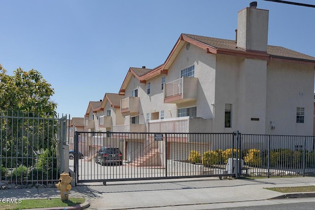 view of gate featuring fence and a residential view