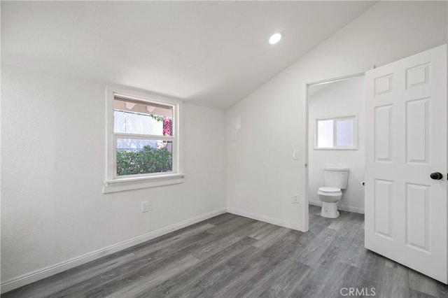 bathroom featuring wood finished floors, lofted ceiling, toilet, baseboards, and recessed lighting