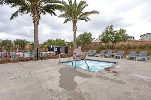view of pool featuring fence and a patio