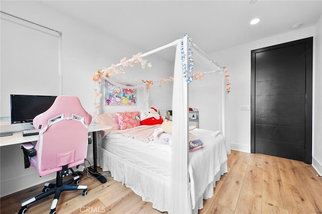 bedroom featuring recessed lighting and wood finished floors