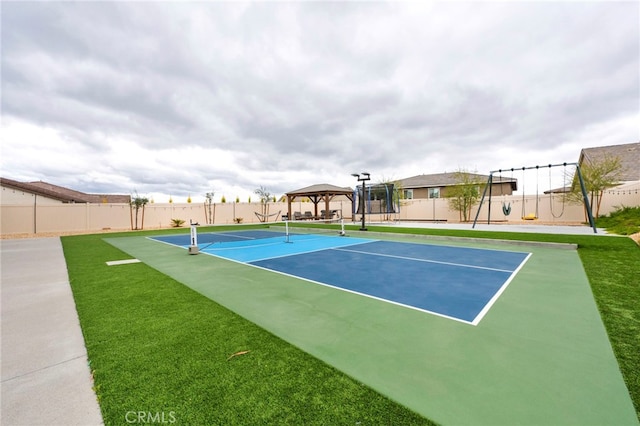 view of sport court featuring fence and a gazebo