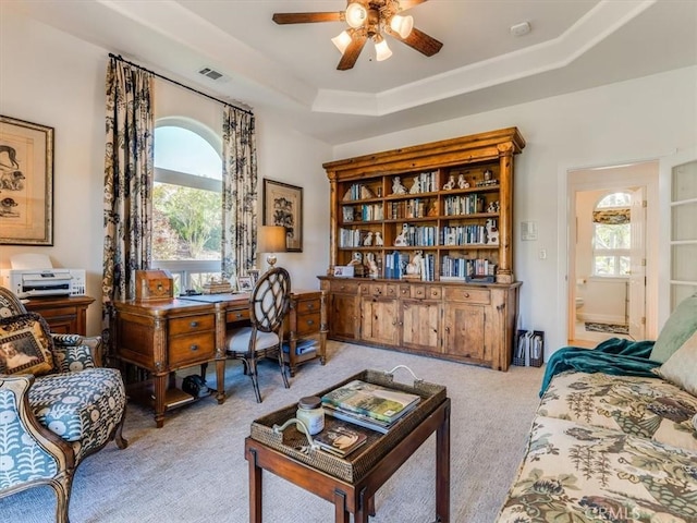 office with a ceiling fan, light colored carpet, visible vents, and a wealth of natural light