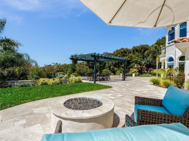 view of patio with a pergola and a fire pit