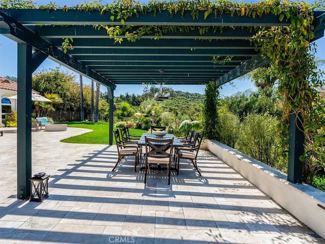 view of patio with a pergola and outdoor dining area