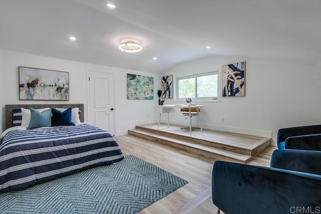 bedroom featuring baseboards, vaulted ceiling, recessed lighting, and wood finished floors