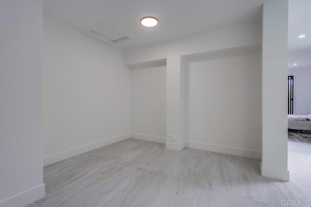 interior space with baseboards and recessed lighting