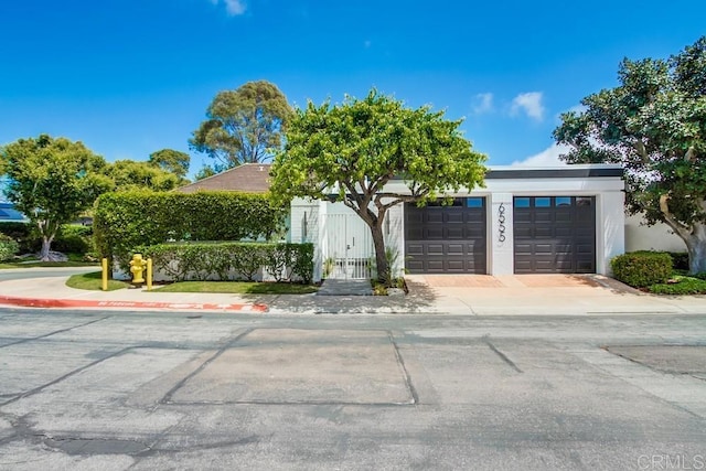 view of front of property with an attached garage and stucco siding