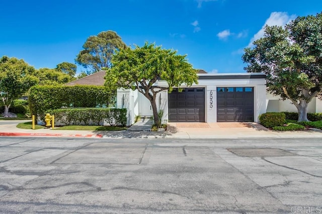 view of front of home featuring stucco siding and a garage