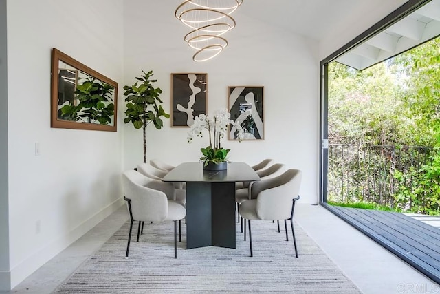 dining room with baseboards and a chandelier