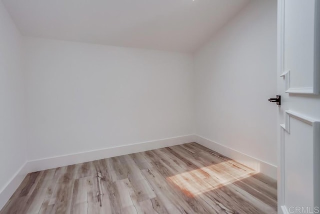 bonus room featuring baseboards, wood finished floors, and lofted ceiling