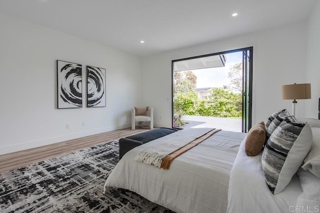 bedroom featuring baseboards, access to outside, recessed lighting, and wood finished floors