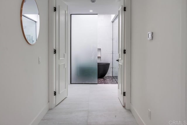 corridor featuring baseboards
