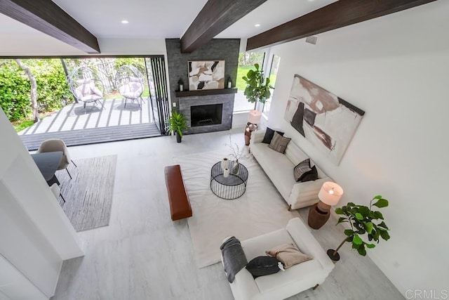living room with a fireplace and beamed ceiling