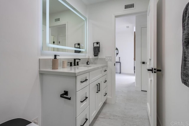 bathroom with visible vents, marble finish floor, and vanity
