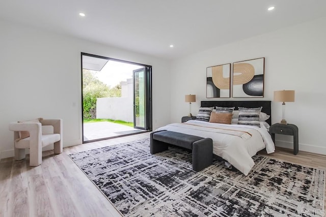 bedroom featuring recessed lighting, baseboards, light wood finished floors, and access to exterior