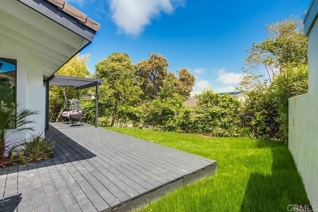 wooden terrace featuring a lawn