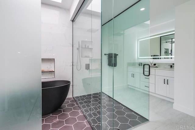 full bath featuring vanity, tile patterned flooring, a freestanding bath, and a stall shower