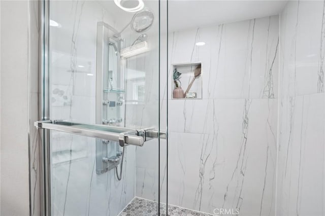 full bathroom with a marble finish shower