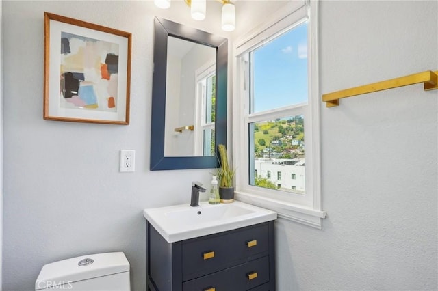 half bathroom featuring toilet and vanity