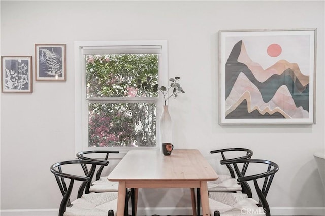 dining space featuring baseboards
