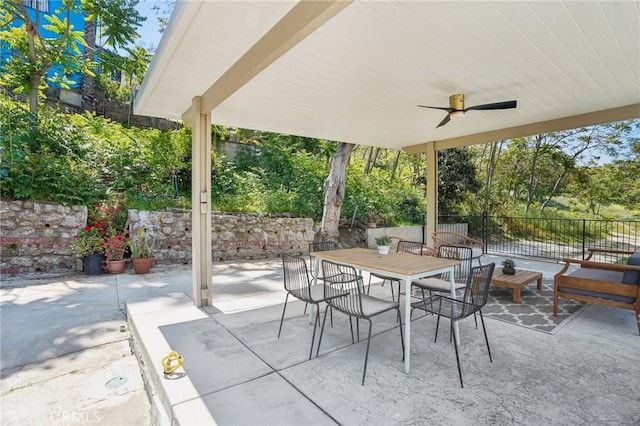 view of patio / terrace featuring fence, a ceiling fan, and outdoor dining space