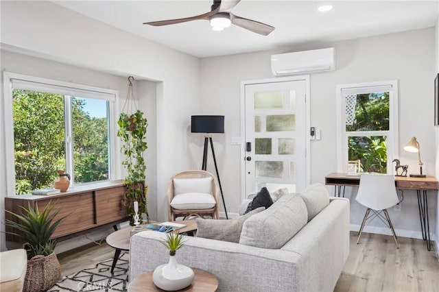 living area with recessed lighting, light wood-style flooring, ceiling fan, and a wall mounted AC
