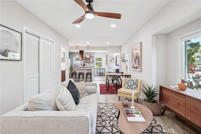 living room with recessed lighting, a ceiling fan, and wood finished floors