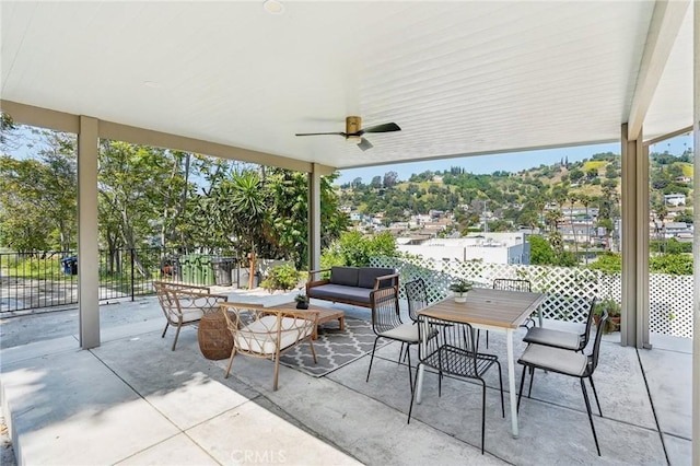 view of patio / terrace with an outdoor living space, fence, a ceiling fan, and outdoor dining area