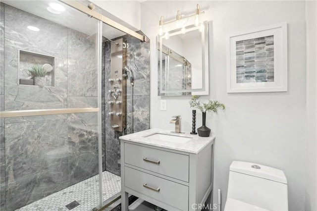 full bath with vanity, a stall shower, and toilet