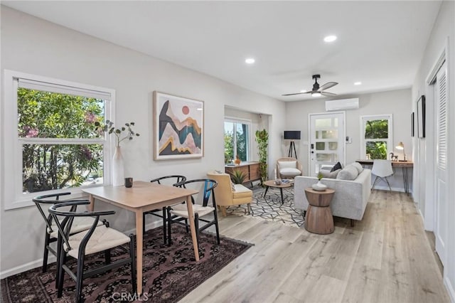 living area with light wood-style floors, recessed lighting, ceiling fan, and a wealth of natural light