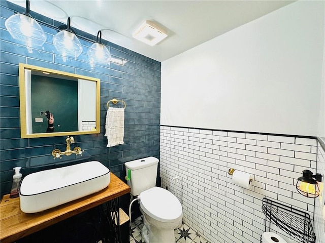 bathroom featuring tile walls, tile patterned flooring, vanity, and toilet