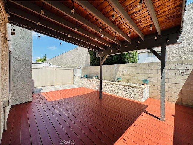deck with a fenced backyard