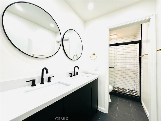 bathroom with toilet, tile patterned floors, a sink, and a stall shower