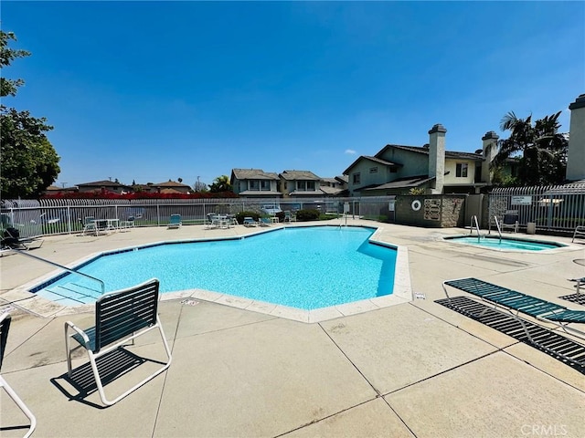 pool featuring a patio and fence