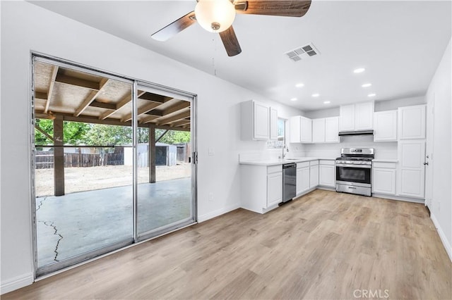 kitchen featuring dishwashing machine, baseboards, stainless steel gas stove, and visible vents
