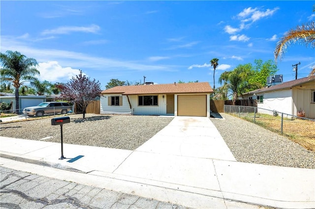 single story home featuring an attached garage, fence, and driveway