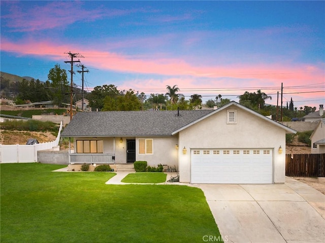 single story home with fence, concrete driveway, a front lawn, and a garage