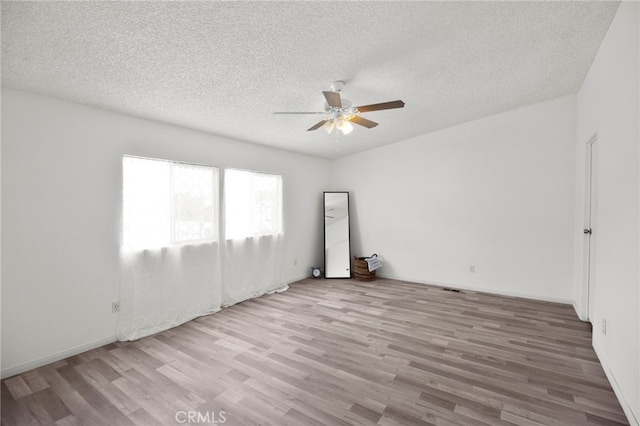 12859 Danbury St, Whitewater, CA 92282 - empty room featuring ceiling fan, wood finished floors, and a textured ceiling