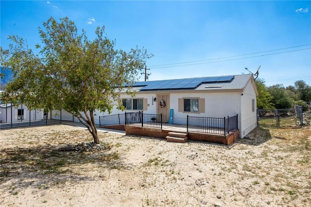 12859 Danbury St, Whitewater, CA 92282 - single story home with roof mounted solar panels, fence, and a deck
