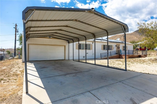 12859 Danbury St, Whitewater, CA 92282 - view of parking / parking lot featuring a garage, a mountain view, fence, and driveway