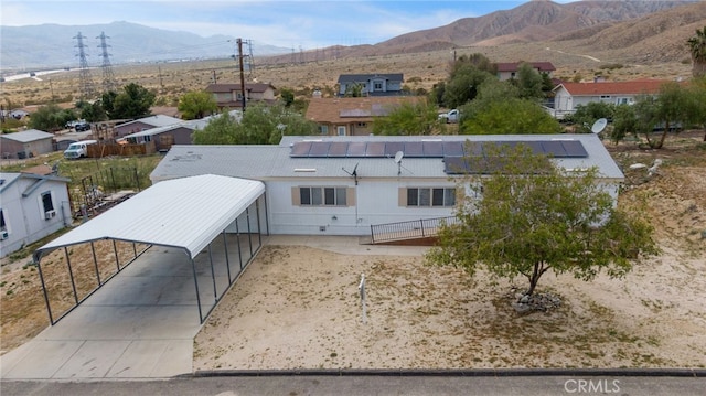 12859 Danbury St, Whitewater, CA 92282 - view of front facade with a mountain view, a residential view, roof mounted solar panels, and fence