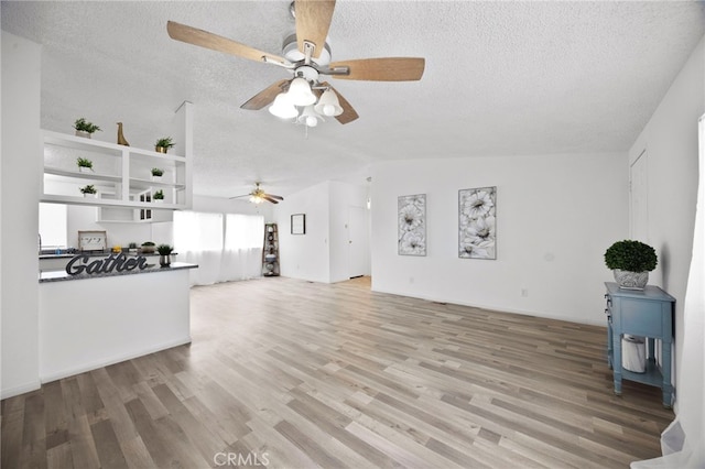 12859 Danbury St, Whitewater, CA 92282 - unfurnished living room featuring vaulted ceiling, ceiling fan, a textured ceiling, and light wood-type flooring